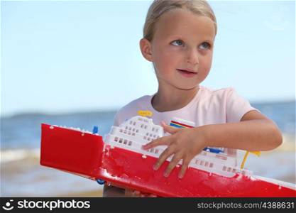 Girl holding toy ship