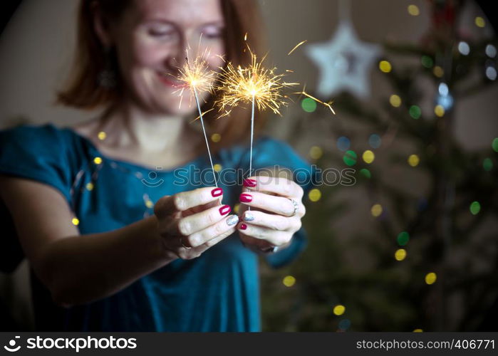 girl holds bengal lights - happy christmas and merry holidays