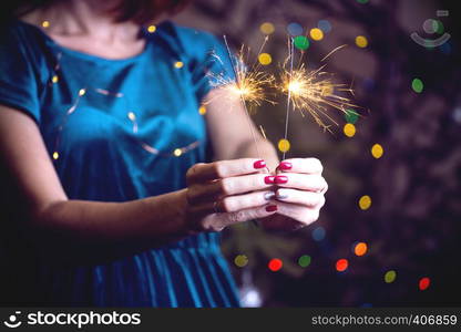 girl holds bengal lights - happy christmas and merry holidays