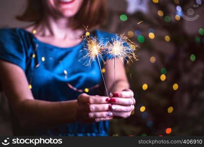 girl holds bengal lights - happy christmas and merry holidays