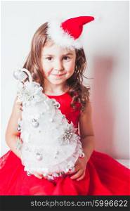 Girl holds in her hands handmade decor - Christmas tree from silver ribbon. Handmade decor - Christmas tree