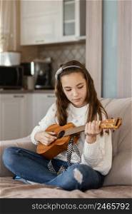 girl home playing guitar