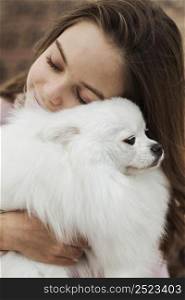 girl hugging her fluffy pup
