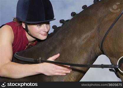 Girl hugging horse, close-up