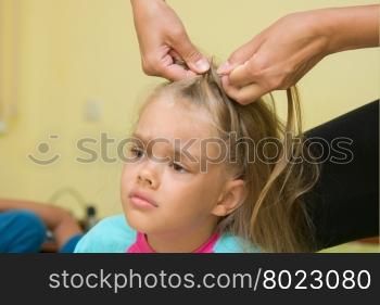 Girl hurt when her long hair braided