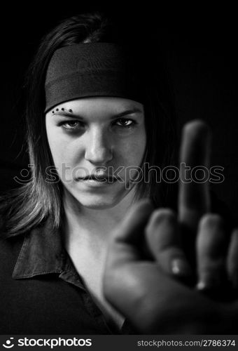 Girl ignoring a middle finger gesture and aggresively staring back (in black and white).