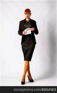 girl in a business dark dress takes a bribe or receives a salary in a paper envelope