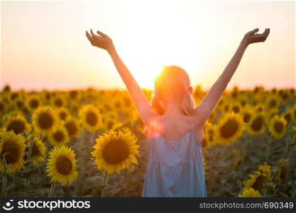 girl in a field of sunflowers at sunset. Ukraine