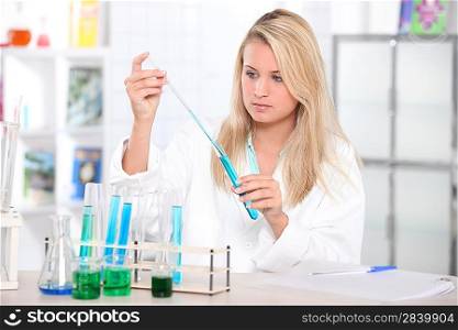 Girl in a laboratory using test tubes