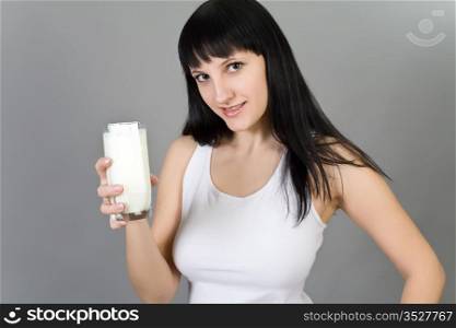 girl in a white vest with a milk glass