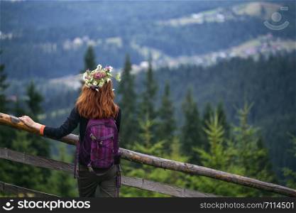 girl in a wreath of wildflowers in the mountains. Carpathians