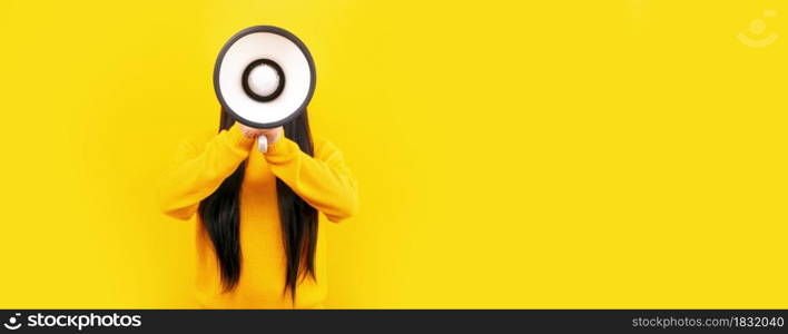 girl in a yellow sweater with a megaphone on a yellow background