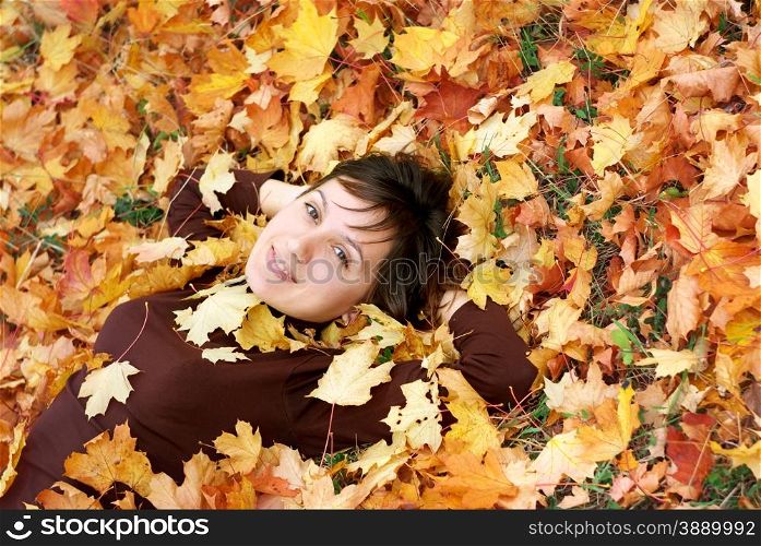 Girl in autumn leafs. Emotional scene.