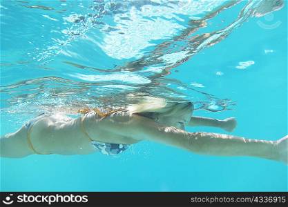 Girl in bikini swimming in pool