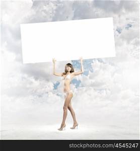 Girl in bikini. Young attractive girl holding white blank banner above head