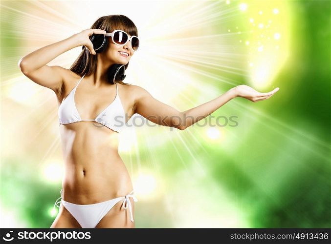 Girl in bikini. Young attractive girl in white bikini and headphones