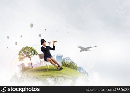 Girl in black cylinder. Pretty girl wearing retro hat siting on chair