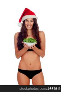 Girl in black underwear and a Santa hat and a salad isolated