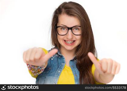 Girl in braces wearing geek glasses showing thumbs up isolated