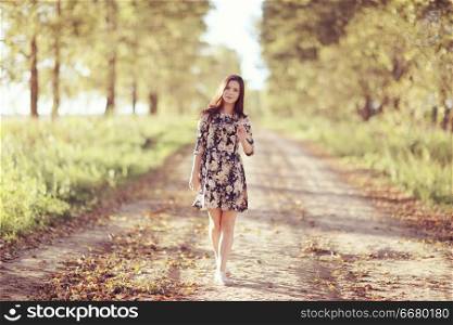 Girl in dress on the summer road