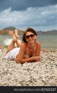 girl in glasses on the shore and smiling