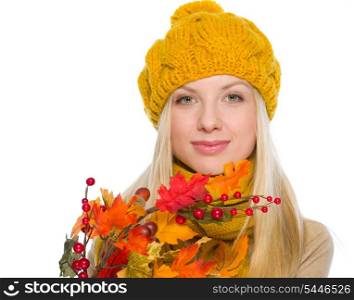 Girl in hat and scarf holding autumn bouquet