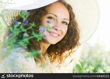 Girl in hat. Young beautiful girl in hat and glasses sitting in grass