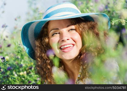 Girl in hat. Young beautiful girl in hat and glasses sitting in grass