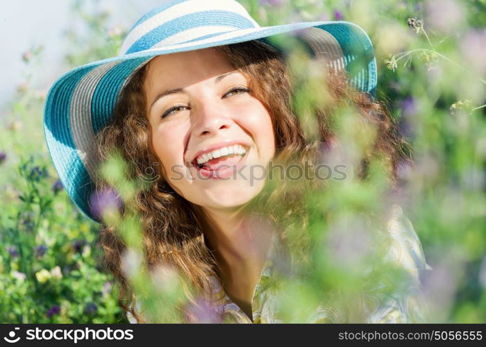 Girl in hat. Young beautiful girl in hat and glasses sitting in grass