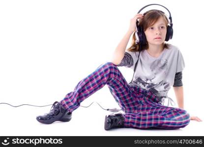 Girl in headphones is listening the music, isolated on white