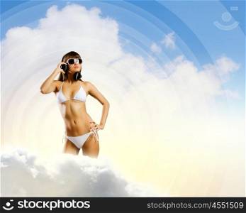 Girl in headphones. Young attractive girl in white bikini wearing headphones