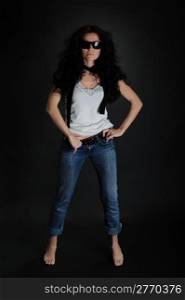 Girl in jeans and a hat full size on a black background