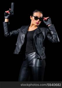 Girl in leather clothes with gun isolated