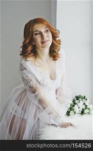 Girl in negligee at the window.. Gentle redhead girl standing at the window 6860.