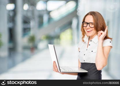 Girl in office clothes with a laptop has thought up solution to the problem