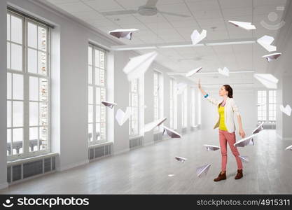 Girl in office interior mixed media. Young woman in modern office interior reaching hand to touch item