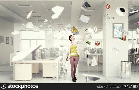 Girl in office interior mixed media. Young woman in modern office interior reaching hand to touch item