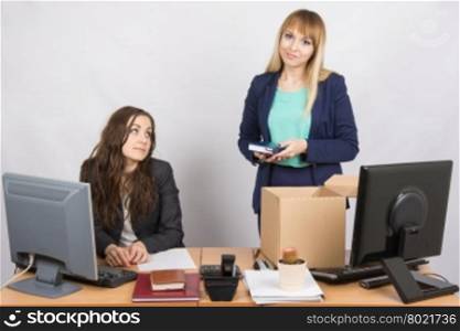 Girl in office standing with a smile in front of a box about colleagues