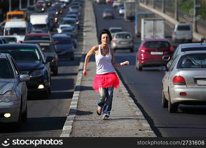 girl in pink skirt runs on highway middle