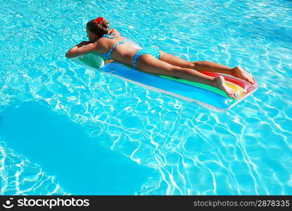 Girl in resort swimming pool