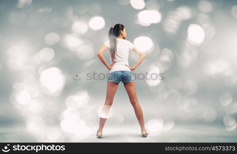 Girl in shorts. Rear view of young girl in denim shorts