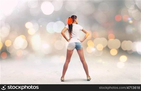 Girl in shorts. Rear view of young girl in denim shorts
