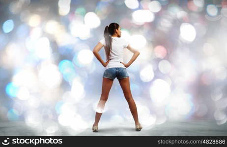 Girl in shorts. Rear view of young girl in denim shorts