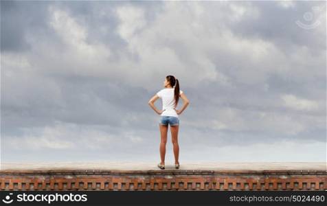 Girl in shorts. Rear view of young girl in denim shorts