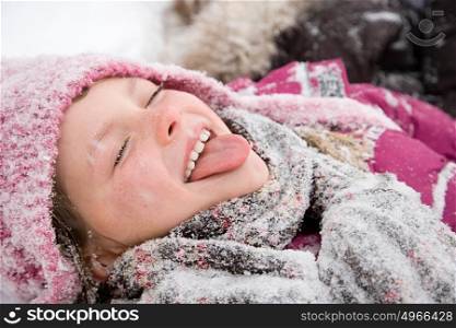 Girl in snow sticking out tongue