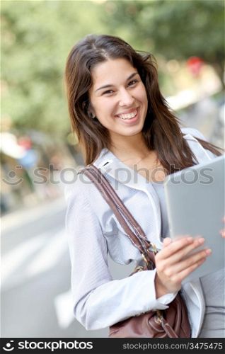 Girl in the street using electronic tablet