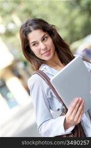 Girl in the street using electronic tablet