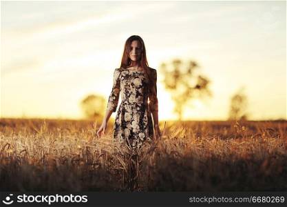 girl in the sunset cloudy sky Field
