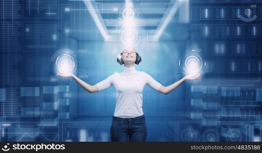 Girl in virtual designed room. Young woman wearing headphones on virtual blue interface