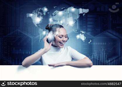 Girl in virtual designed room. Young woman wearing headphones on virtual blue interface